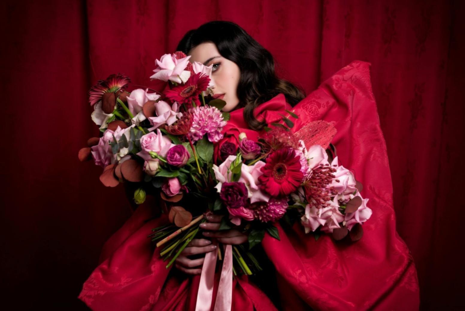 Floristry instructor demonstrating arrangement techniques during live online session